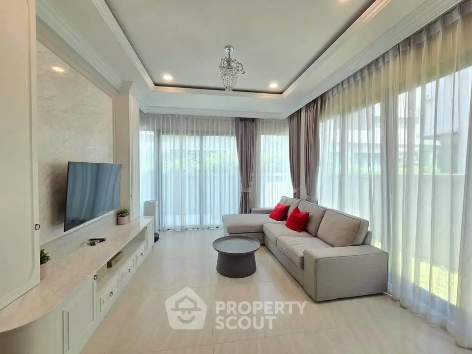 Spacious living room with elegant decor and large windows for natural light