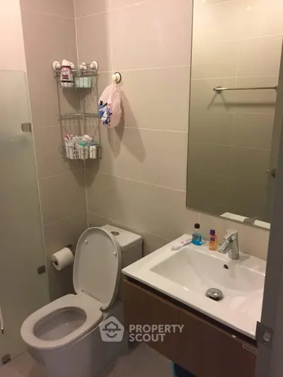 Modern bathroom with sleek fixtures and ample storage space.