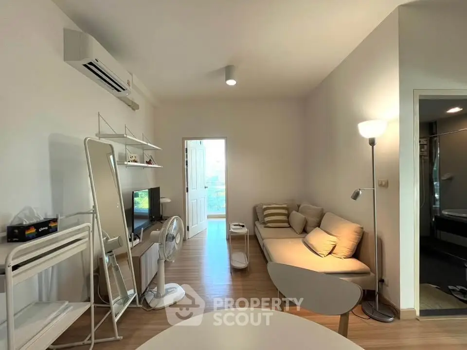 Cozy living room with modern furniture and natural light, perfect for relaxation.