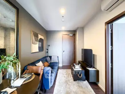 Modern living room with stylish decor and cozy seating area in a contemporary apartment.