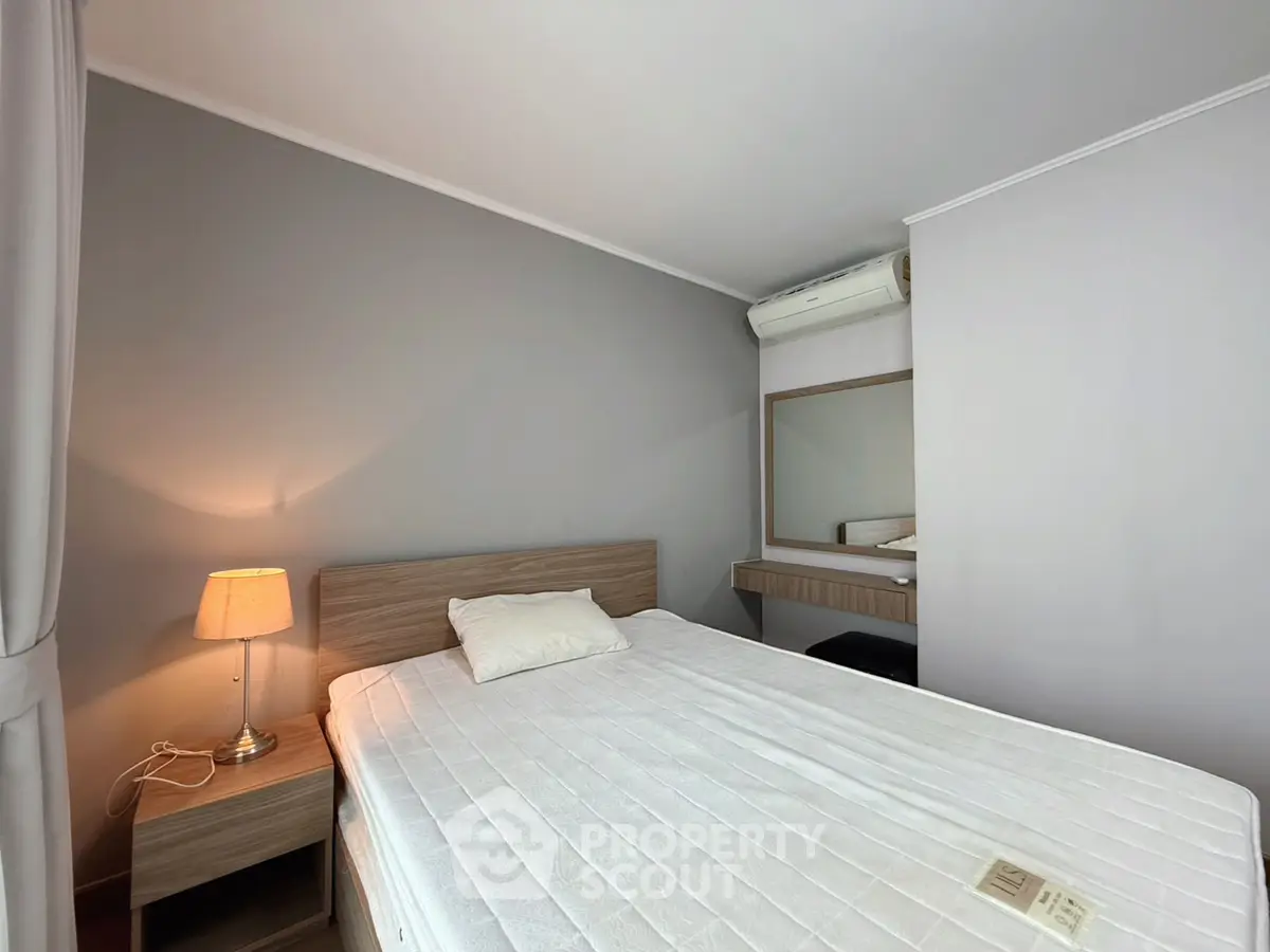 Cozy bedroom with modern furnishings and soft lighting, perfect for relaxation.