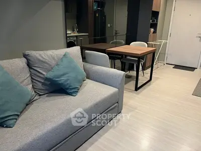 Modern living room with cozy sofa and dining area in stylish apartment