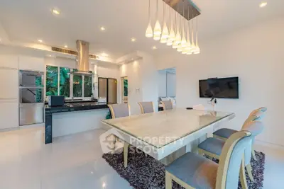 Luxurious dining area with modern lighting and sleek kitchen design