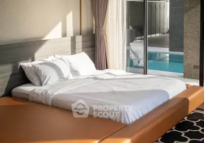 Luxurious bedroom with pool view and modern design, perfect for relaxation and comfort.