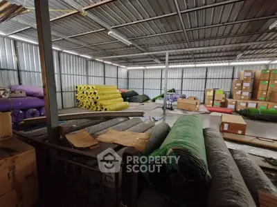 Spacious industrial warehouse with stacked materials and organized storage.