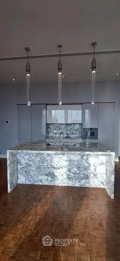 Luxurious kitchen with marble island and modern lighting fixtures