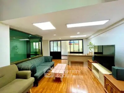 Spacious living room with modern furniture and wooden flooring