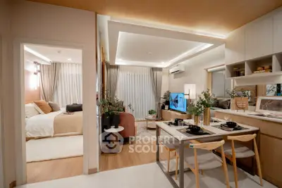 Modern open-plan living and dining area with cozy bedroom view, featuring stylish decor and ambient lighting.