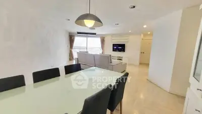 Spacious living room with modern dining area and natural light