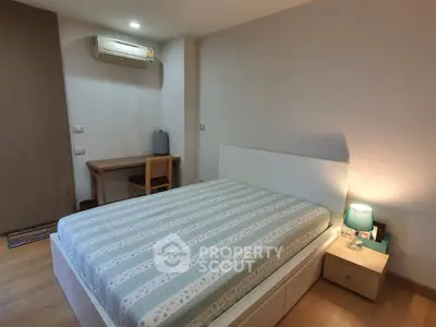 Cozy bedroom with modern furniture and soft lighting, perfect for relaxation.