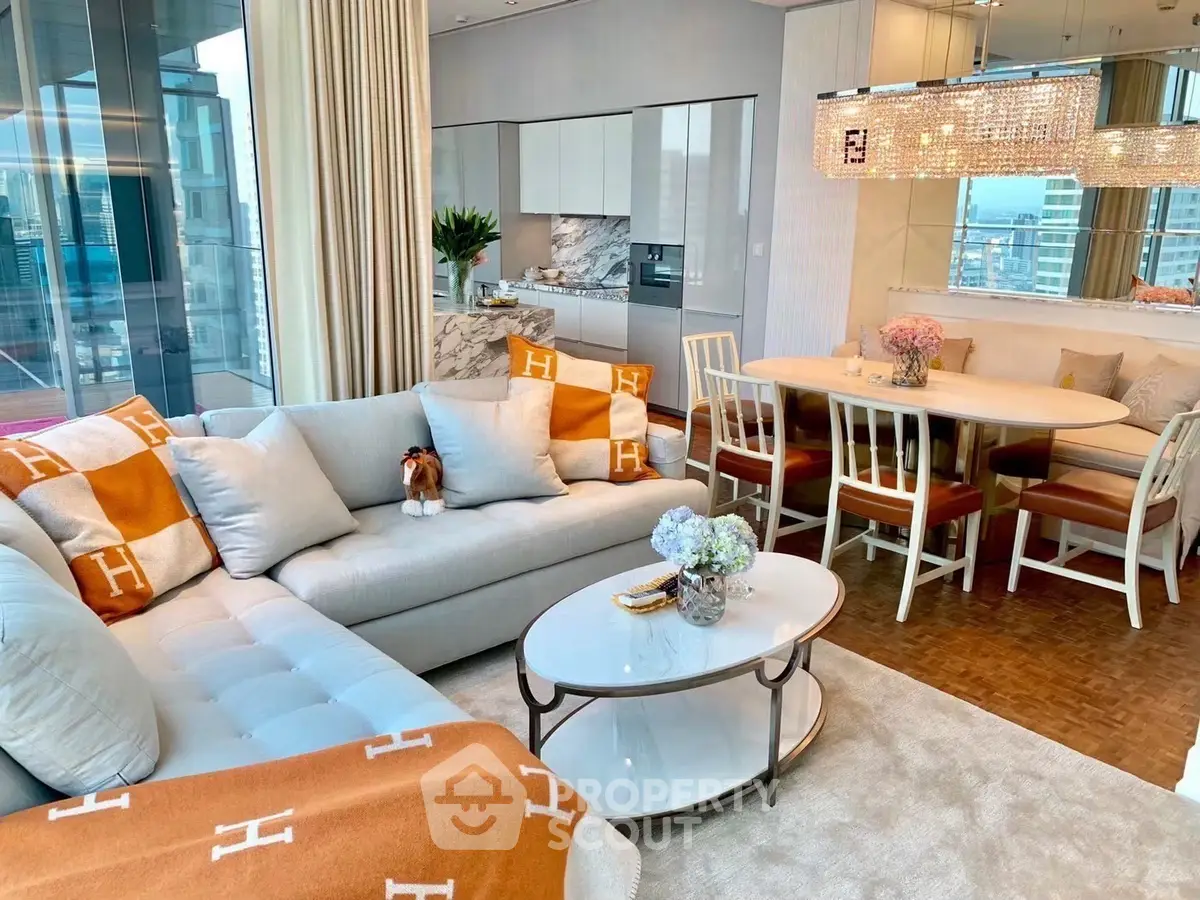 Luxurious modern living room with open kitchen and elegant dining area, featuring chic decor and city views.