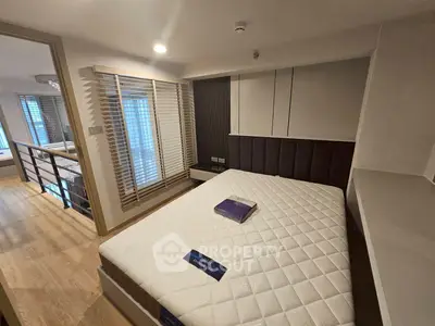 Modern bedroom with stylish decor and natural light in a contemporary apartment