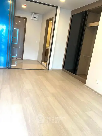 Spacious modern interior with sleek flooring and open closet space, ideal for contemporary living.