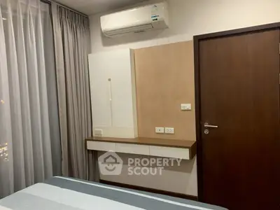 Modern bedroom with air conditioning and sleek wooden accents, perfect for comfortable living.