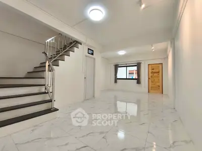 Spacious modern interior with marble flooring and staircase, perfect for contemporary living.