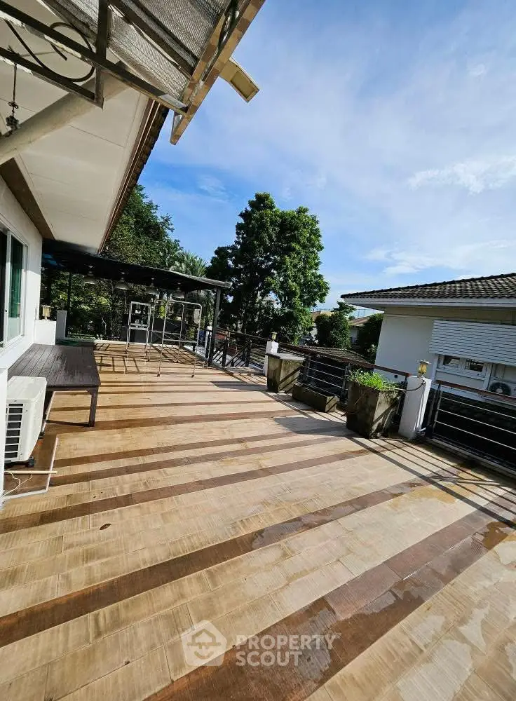 Spacious rooftop terrace with modern railing and scenic view