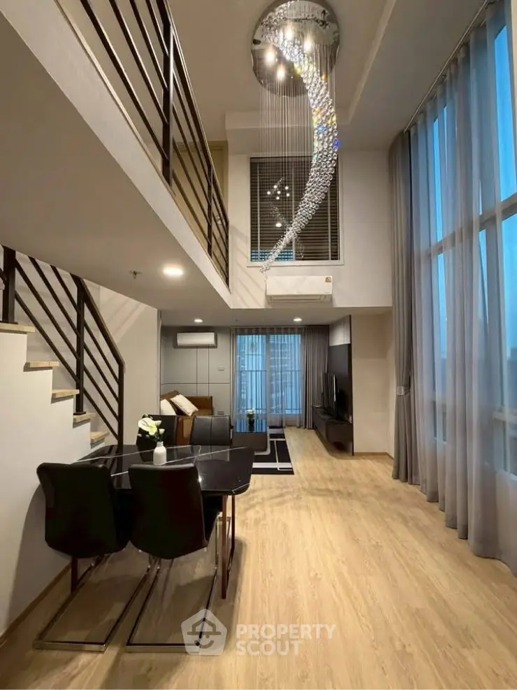 Luxurious duplex living room with high ceilings and elegant chandelier