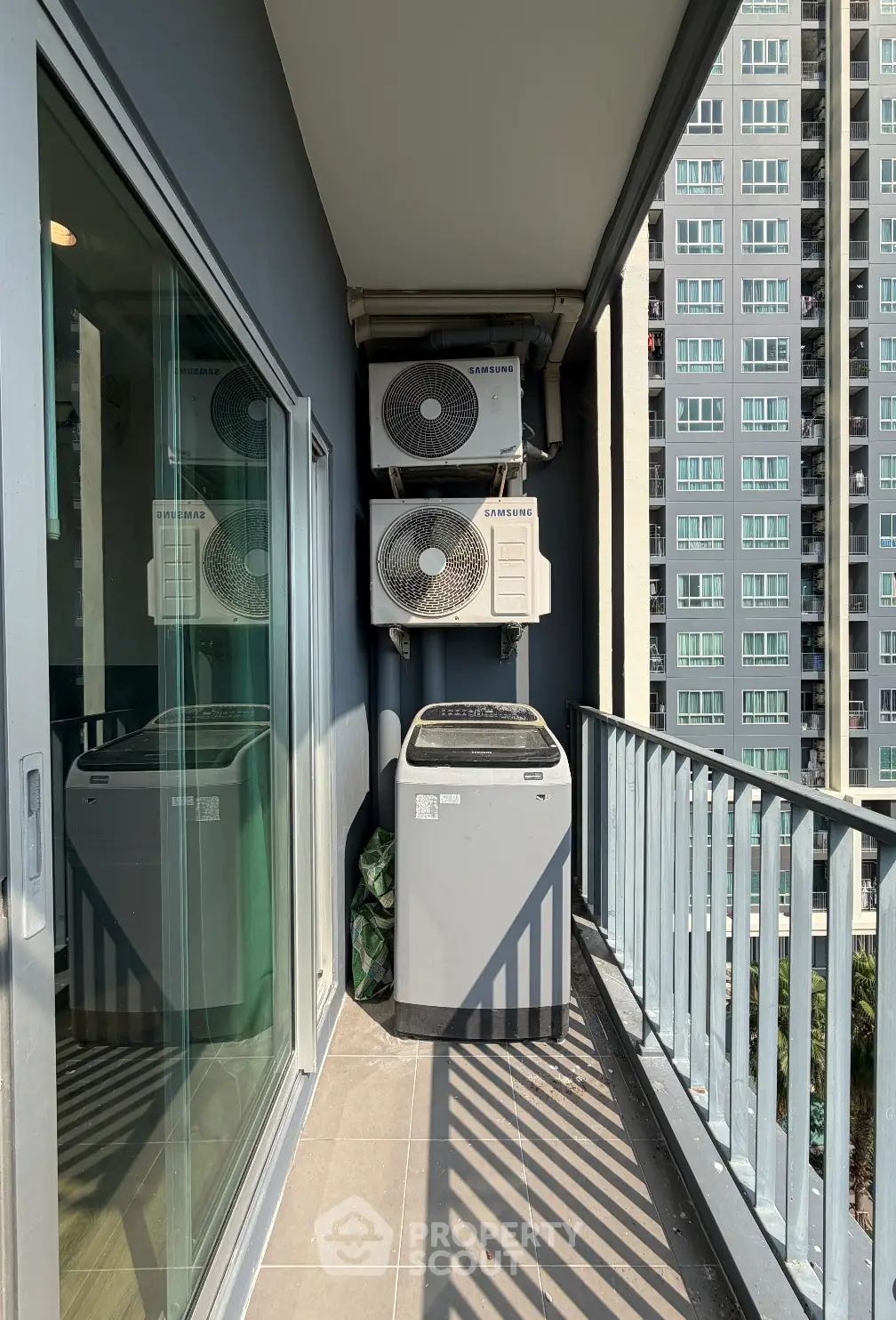 Modern balcony with air conditioning units and city view