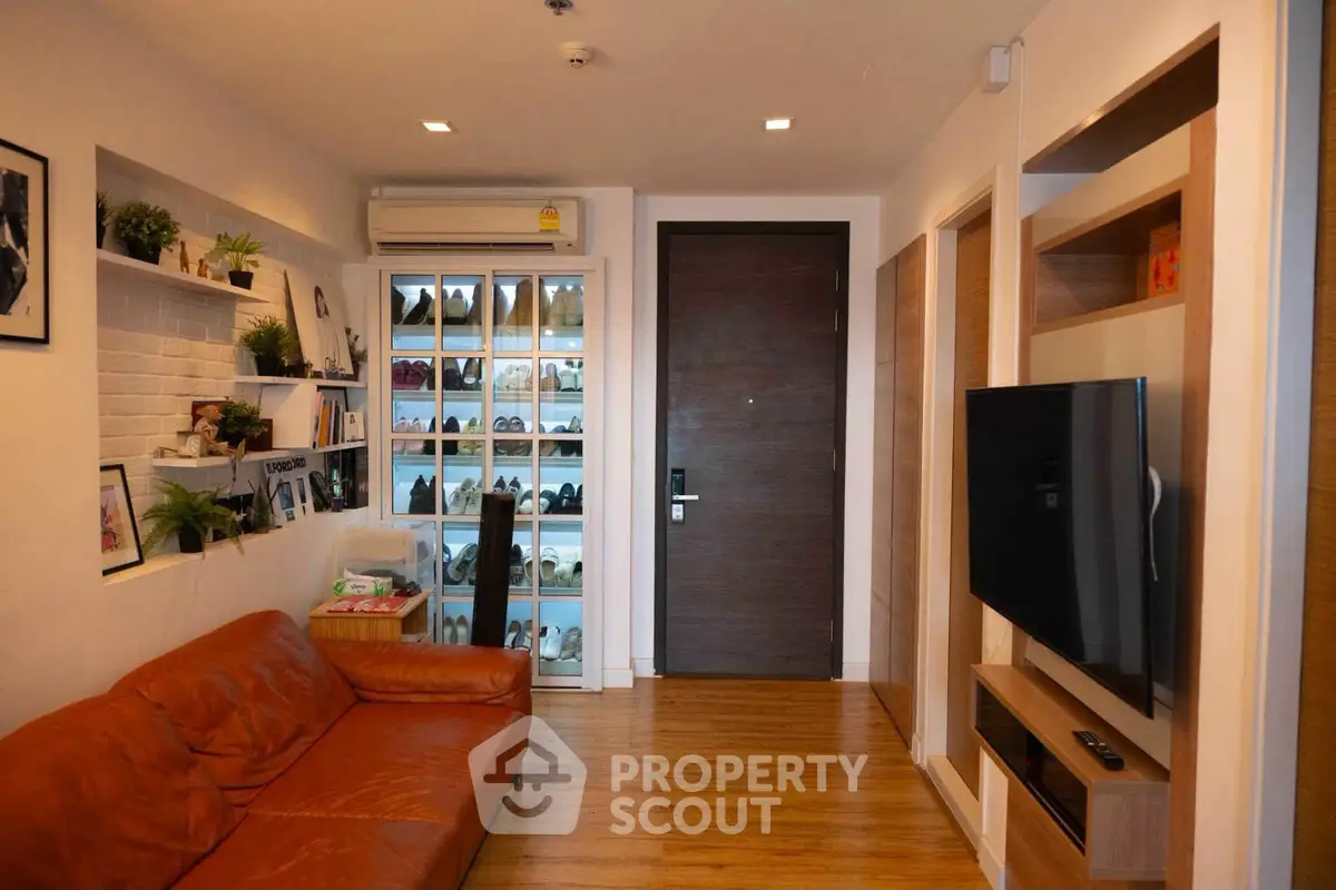 Stylish living room with leather sofa and modern TV setup in cozy apartment
