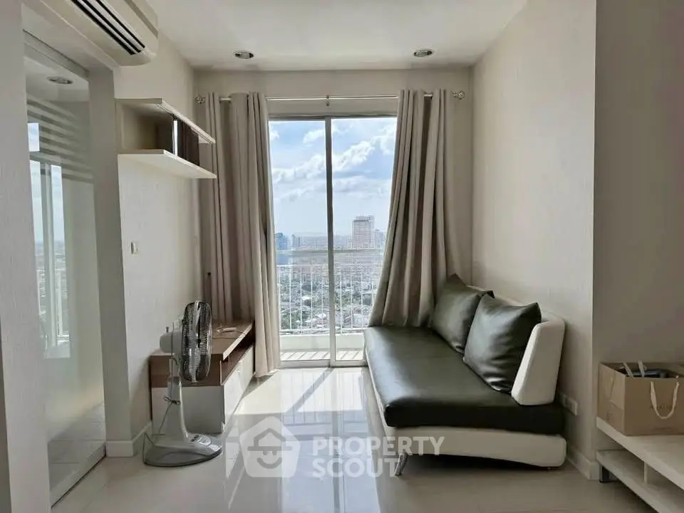 Modern living room with city view, sleek furniture, and natural light.
