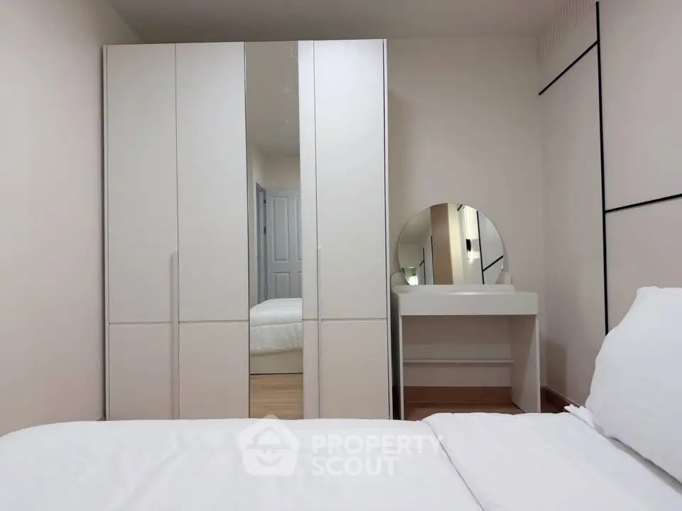 Modern bedroom with sleek wardrobe and stylish vanity mirror