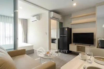 Modern studio apartment with open layout, featuring a cozy living area, sleek kitchen, and comfortable bedroom.