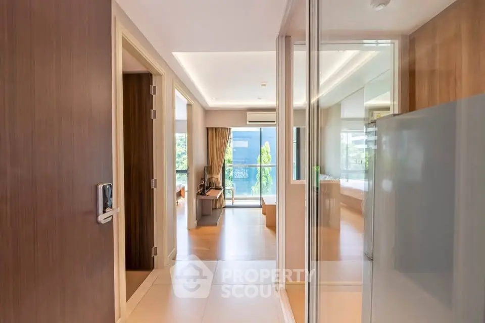 Spacious modern apartment interior with open layout and large windows offering natural light.