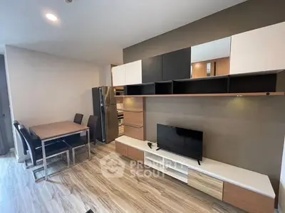 Modern living room with sleek furniture and open kitchen layout