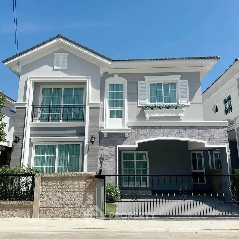Stunning modern two-story house with elegant facade and spacious driveway, perfect for family living.