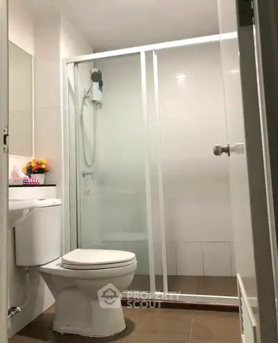 Modern bathroom with glass shower enclosure and sleek fixtures