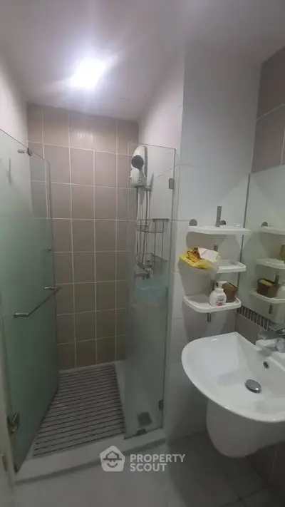 Modern bathroom with glass shower enclosure and sleek fixtures