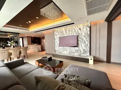 Luxurious modern living room with open kitchen and elegant marble accents.