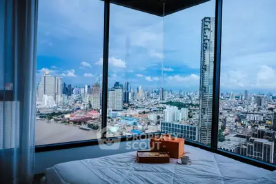Luxurious bedroom with panoramic city view from floor-to-ceiling windows.