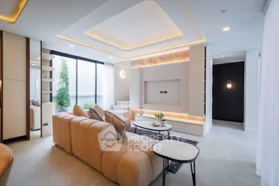 Luxurious modern living room with elegant lighting and plush beige sofa, perfect for relaxation and entertainment.