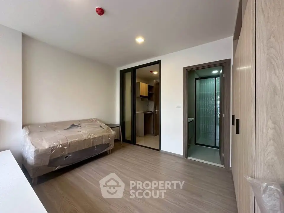 Modern apartment interior with compact living space and kitchenette