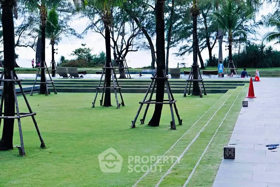 Luxurious garden area with manicured lawns and palm trees, perfect for relaxation and outdoor activities.