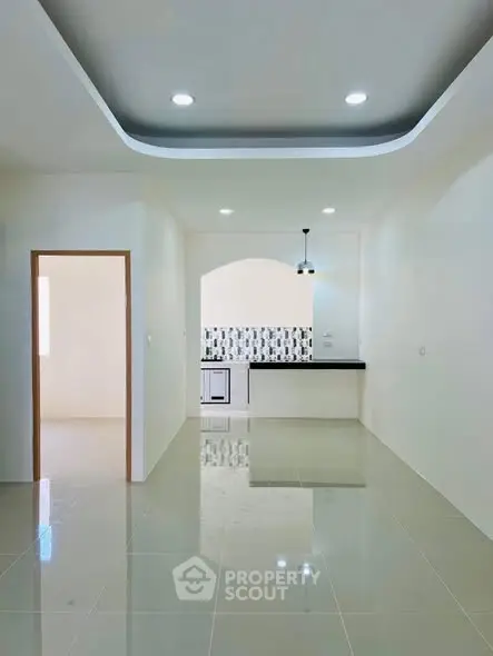 Modern open-plan kitchen with sleek design and stylish lighting in a bright apartment.