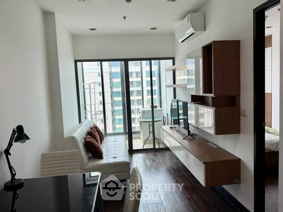 Modern living room with sleek furniture and balcony view in urban apartment