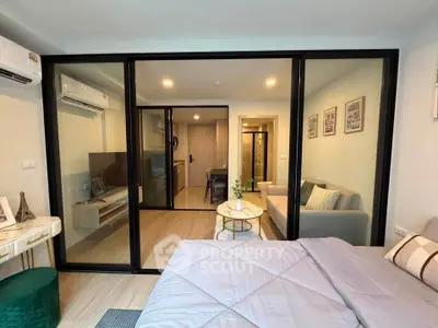 Modern studio apartment with glass partition, cozy living area, and stylish decor
