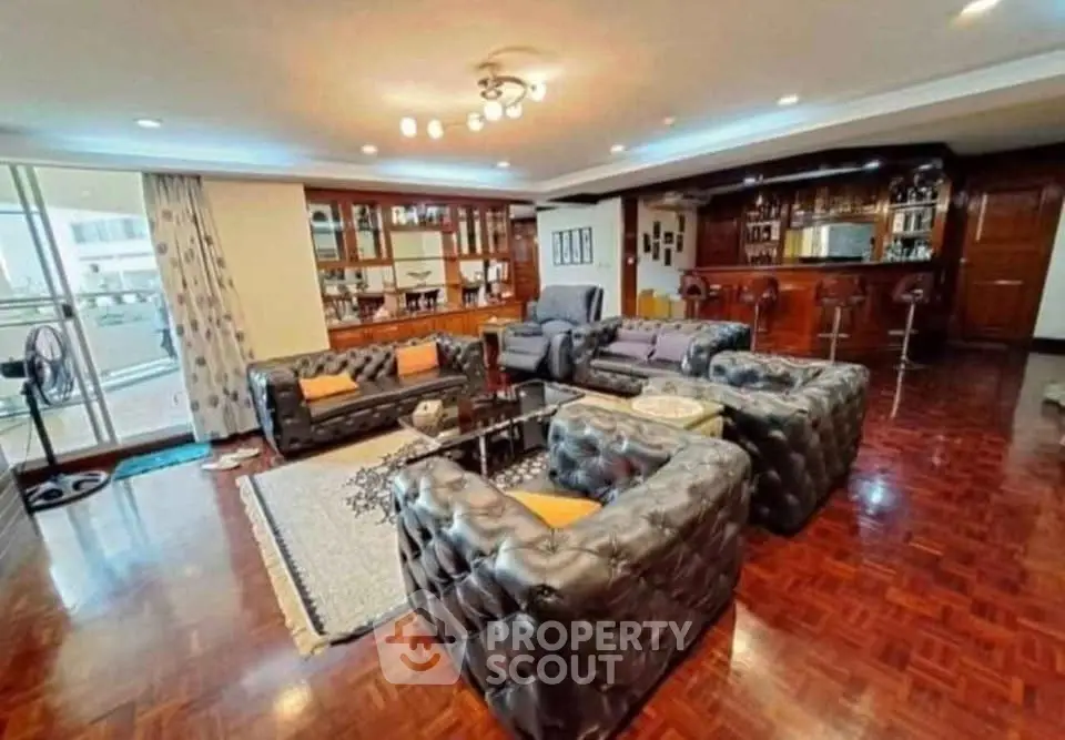 Luxurious living room with elegant leather sofas and open kitchen in a spacious apartment.