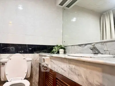Elegant bathroom with marble countertop and modern fixtures in a stylish real estate property.