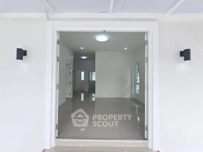 Spacious modern living room with sleek tile flooring and ample natural light.