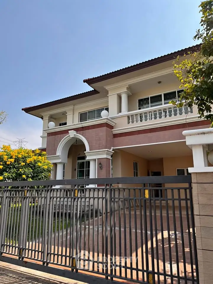 Elegant two-story house with classic architecture and spacious front yard