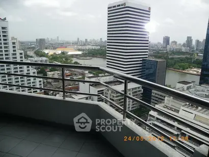 Stunning cityscape view from a high-rise balcony with modern railing.