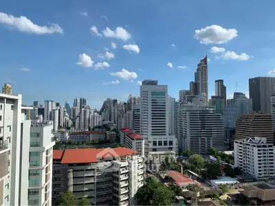 Stunning cityscape view of modern skyscrapers under a clear blue sky, perfect for urban living enthusiasts.