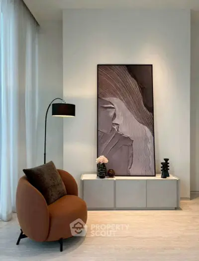 Stylish modern living room with elegant decor and contemporary art piece.