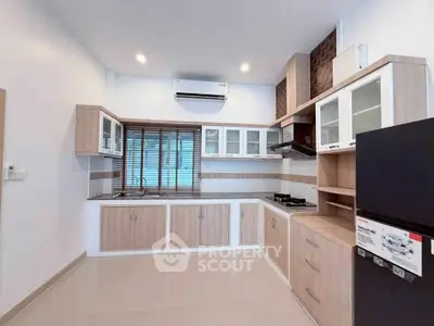 Modern kitchen with sleek cabinetry and gas stove in a stylish apartment.