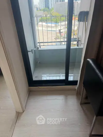 Cozy apartment balcony with city view and sliding glass door