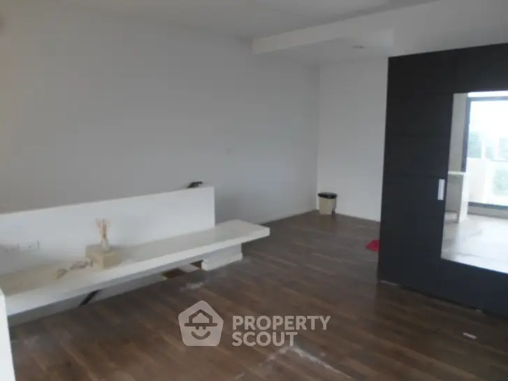 Spacious modern living room with wooden flooring and minimalist design