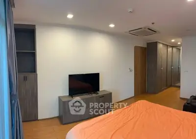 Spacious bedroom with modern furniture and built-in wardrobe